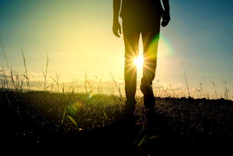 male walking with silhouette sunrise