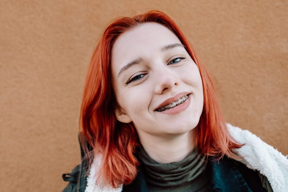 Smiling Redhead Teen Girl with Braces Posing in Warm Winter Clothing