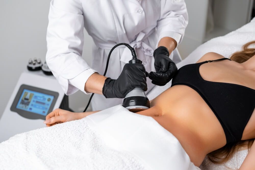 Engaging in ultrasound cavitation therapy for body contouring