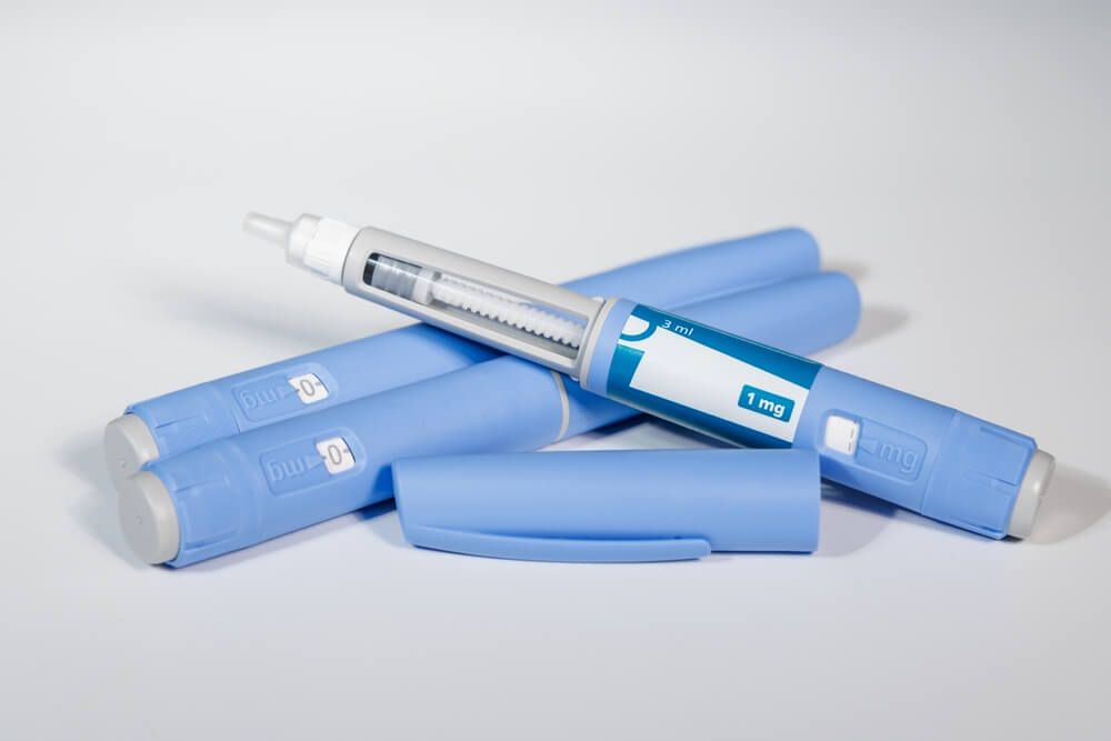 GLP-1 semaglutide injection pens with pills and measuring tape