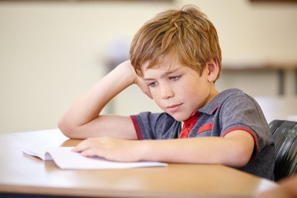 Class, book and bored child at desk, learning