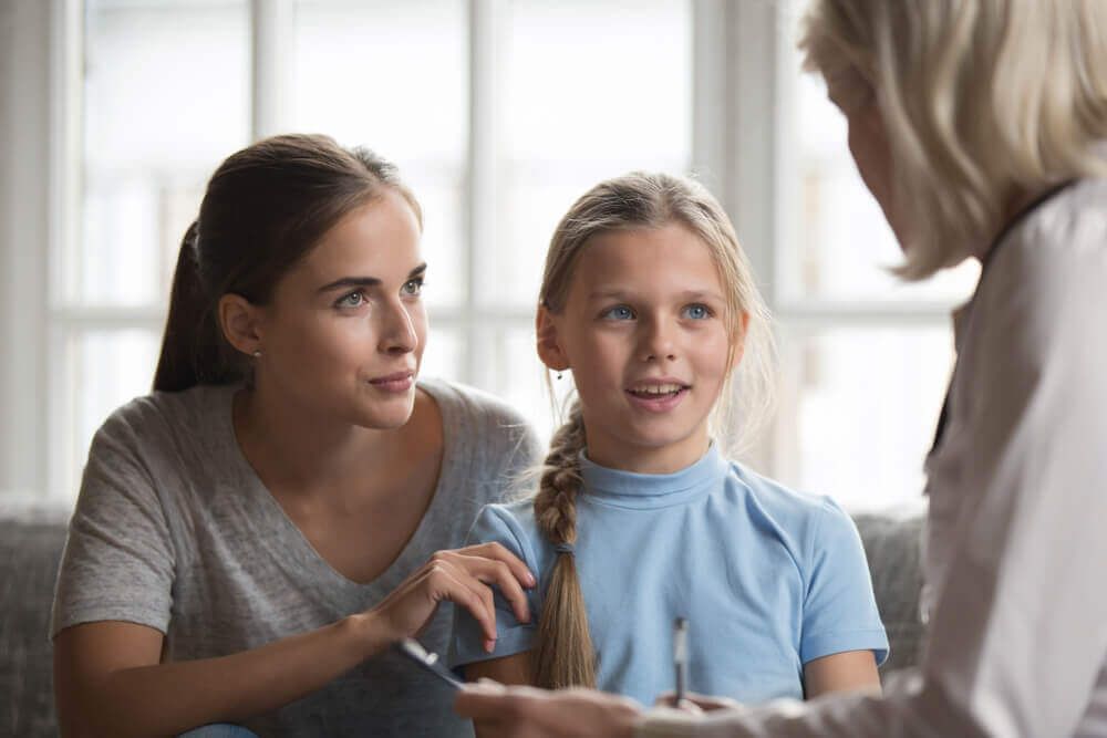 Parent and child seeing psychologist together.