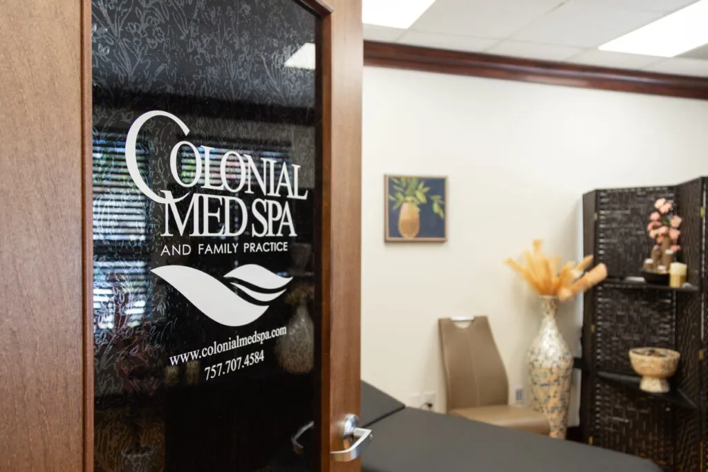 Clean, professional medical spa treatment room with neutral tones at Colonial Med Spa in Newport News