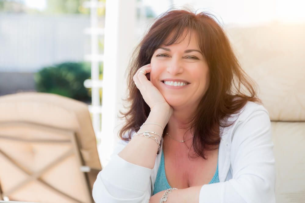 Attractive Middle Aged Woman Smiles On The Patio.