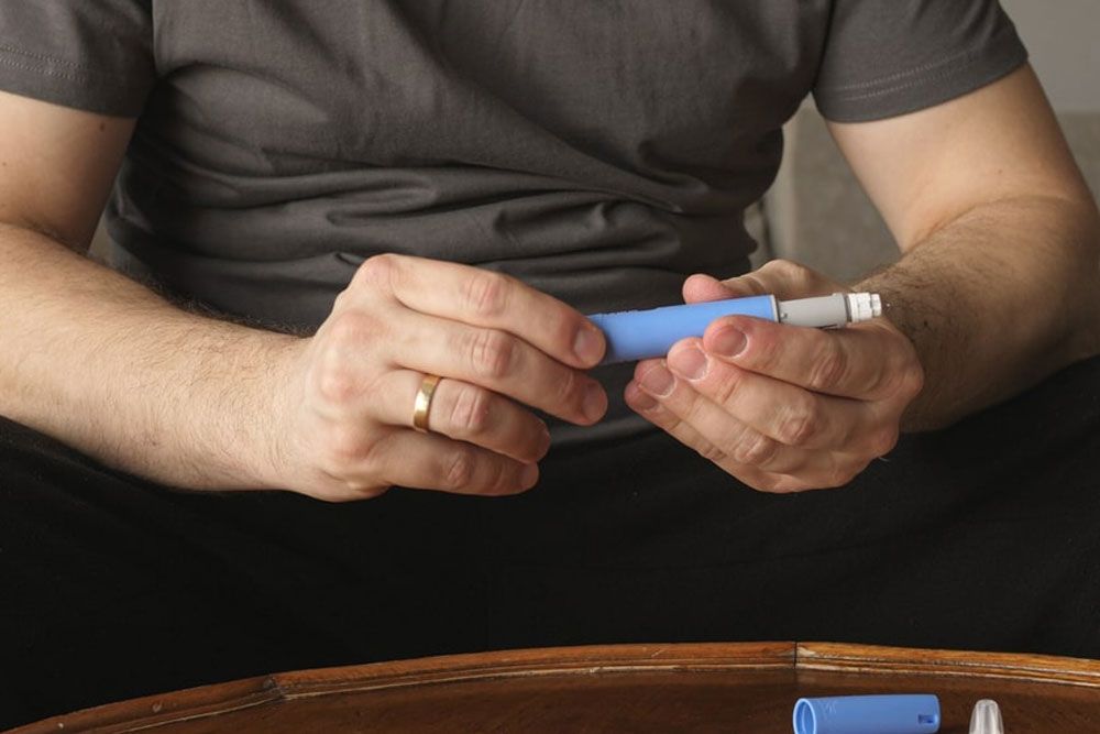 obese fat man preparing Semaglutide Ozempic injection control blood sugar levels