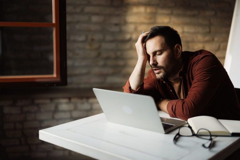 Sleepy office worker feeling drained and exhausted during a busy workday.