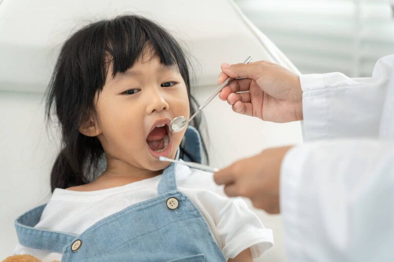 Child receiving treatment from dentist