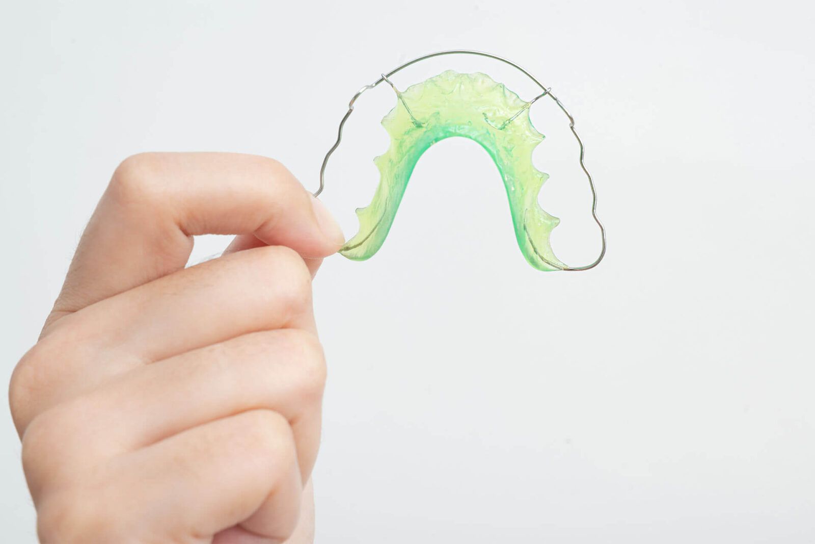 Woman hand holding orthodontic retainers