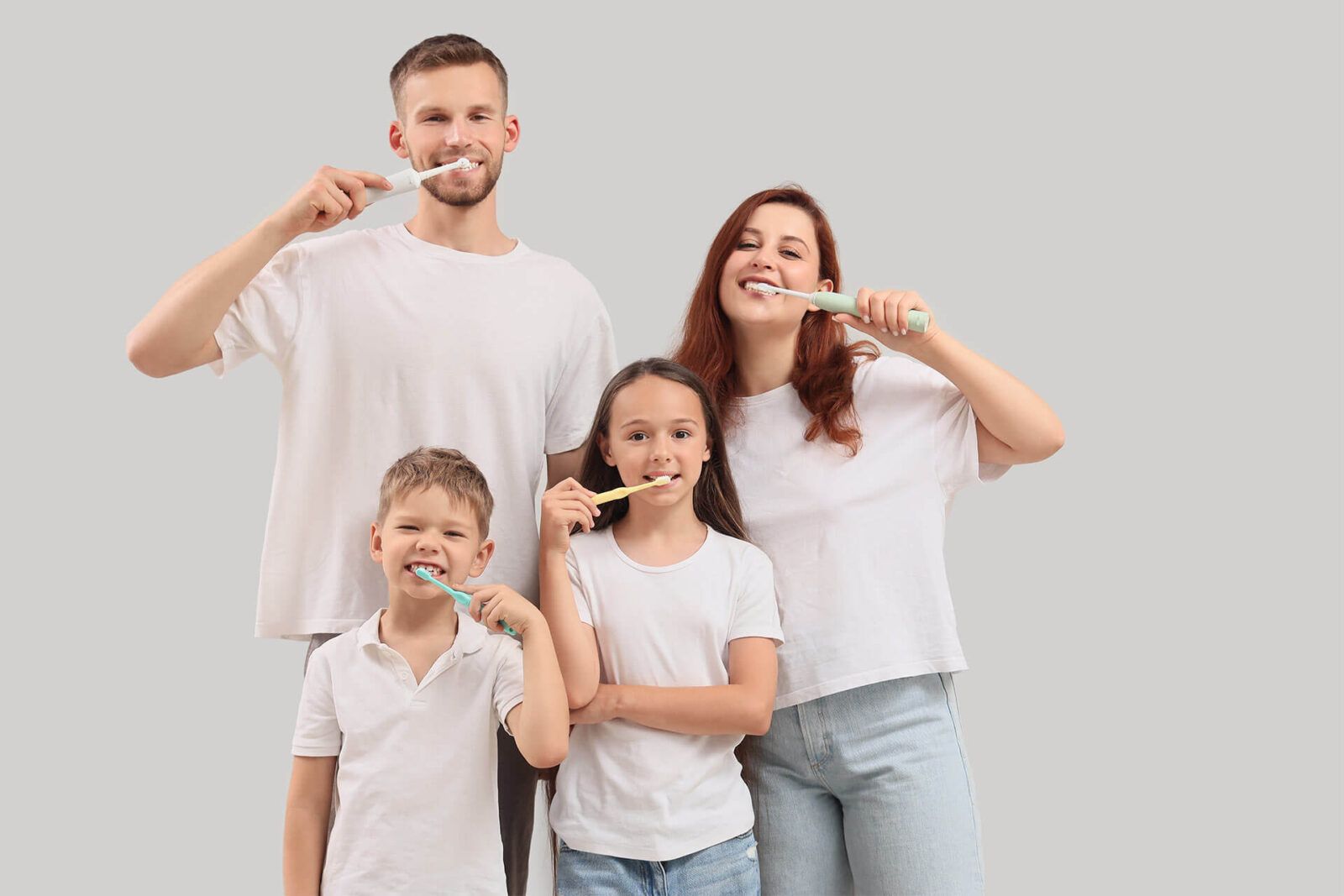 Happy family brushing teeth