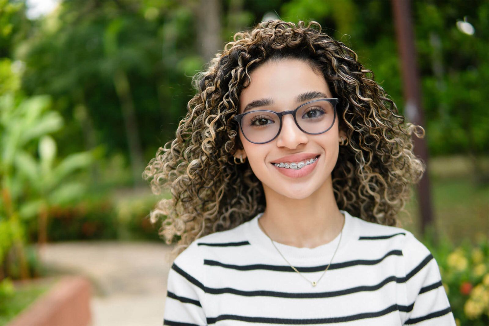 Young hispanic university student smiling