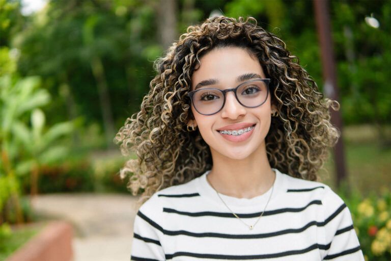Young hispanic university student smiling