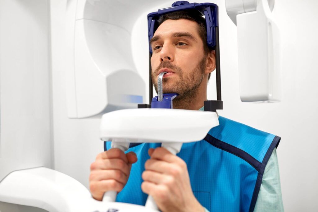 male patient having panoramic x-ray scanning procedure at dental clinic