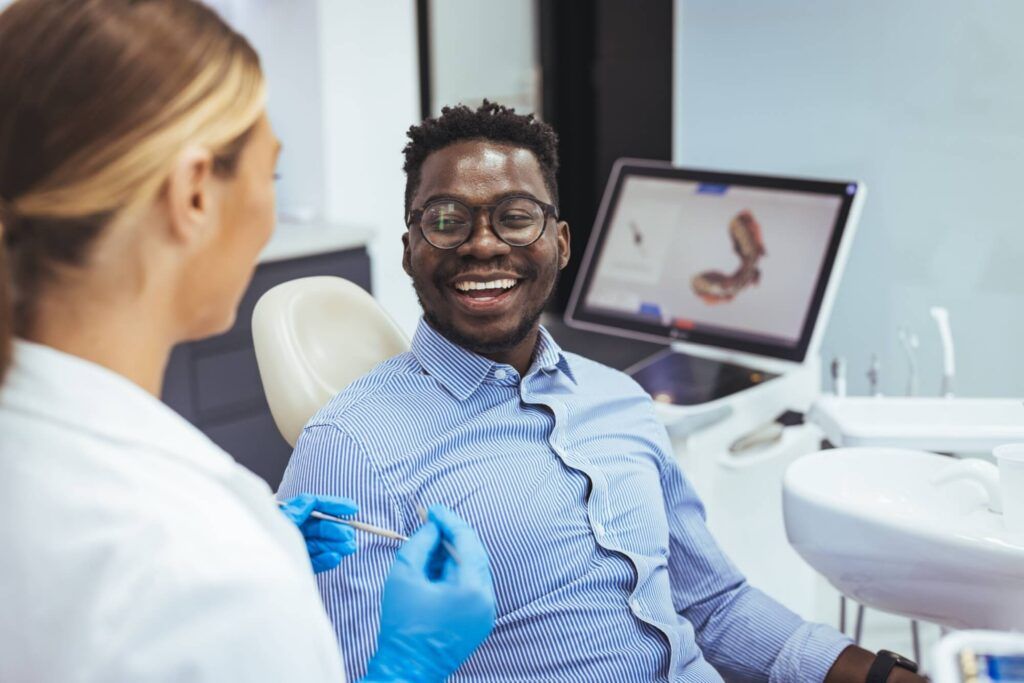 African American young man having a visit at the dentist's clinic