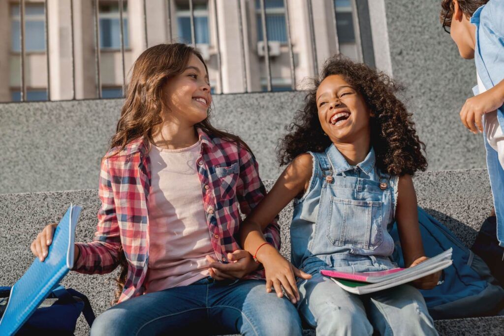 Portrait of cheerful positive school pupils friends preteen boys and girls classmates laughing