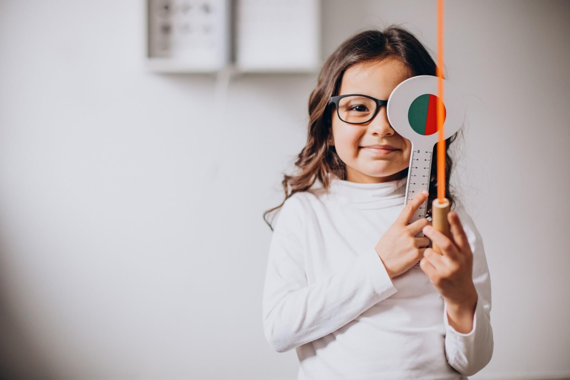 Little girl checking up her sight at ophthalmology center