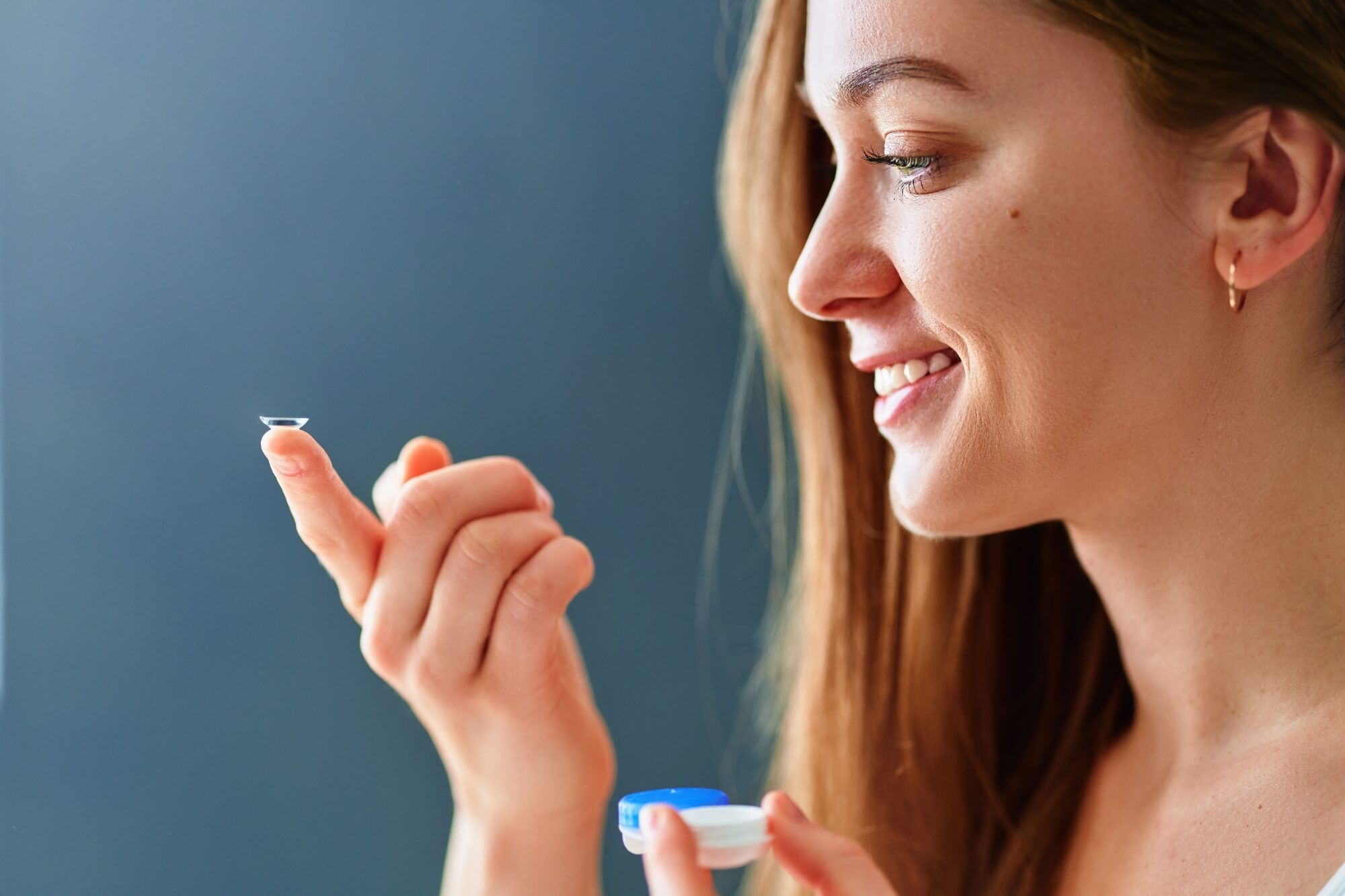 Young woman using soft contact lenses instead of glasses