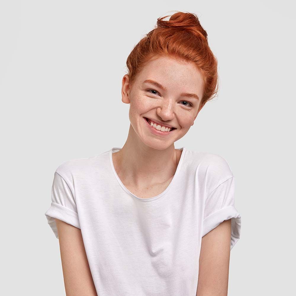 portrait of positive glad ginger young female
