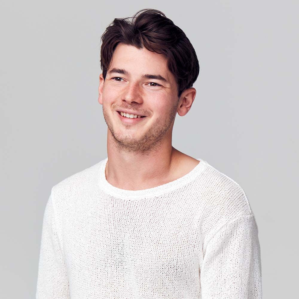 studio portrait of young man wearing white t shirt