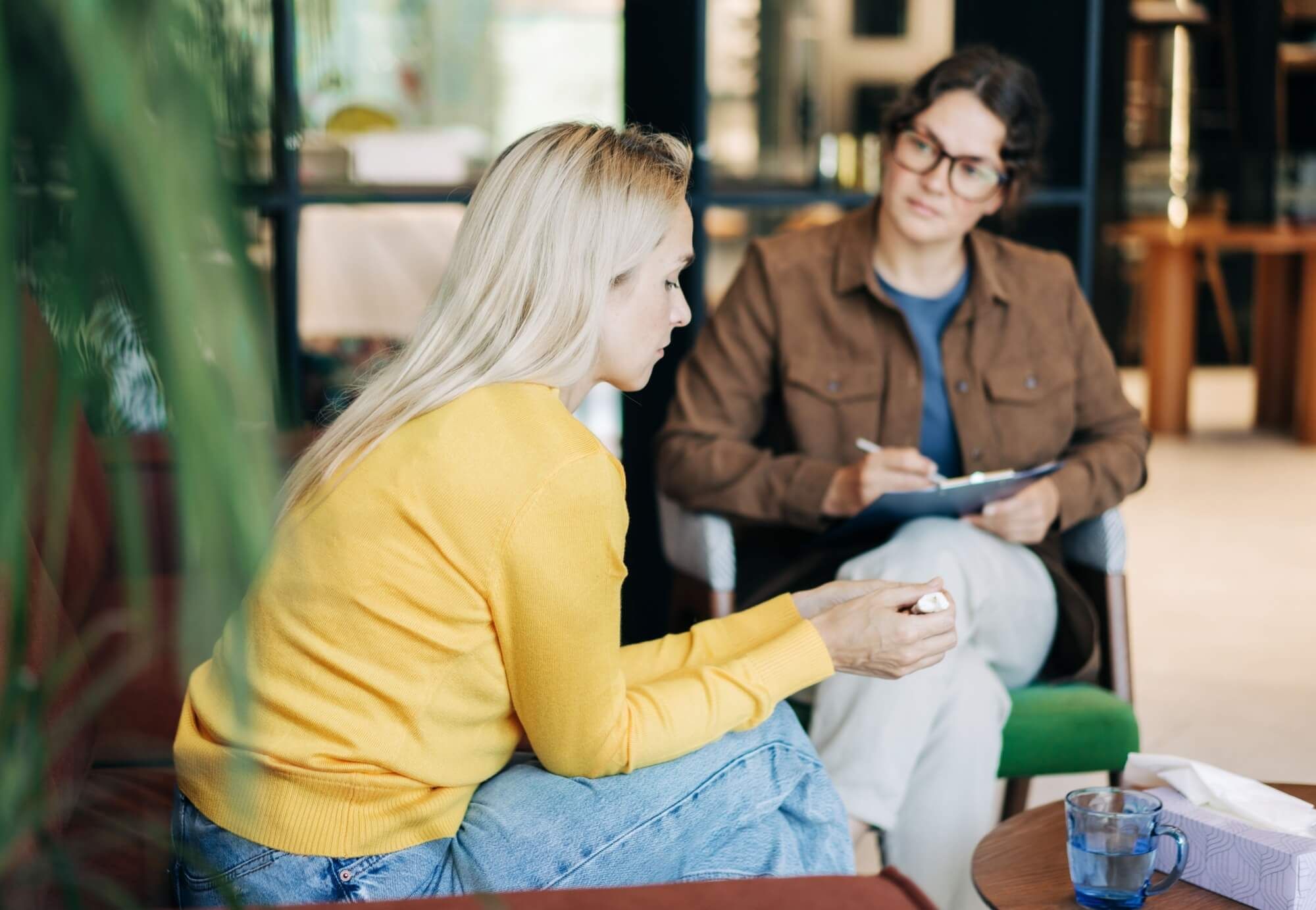 Psychologist writing down notes about a patient in a notebook. The psychologist makes a social survey of the reference group