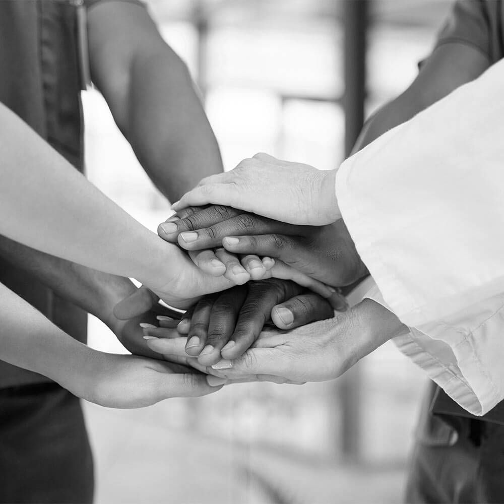 Medical team, hands and people huddle for support