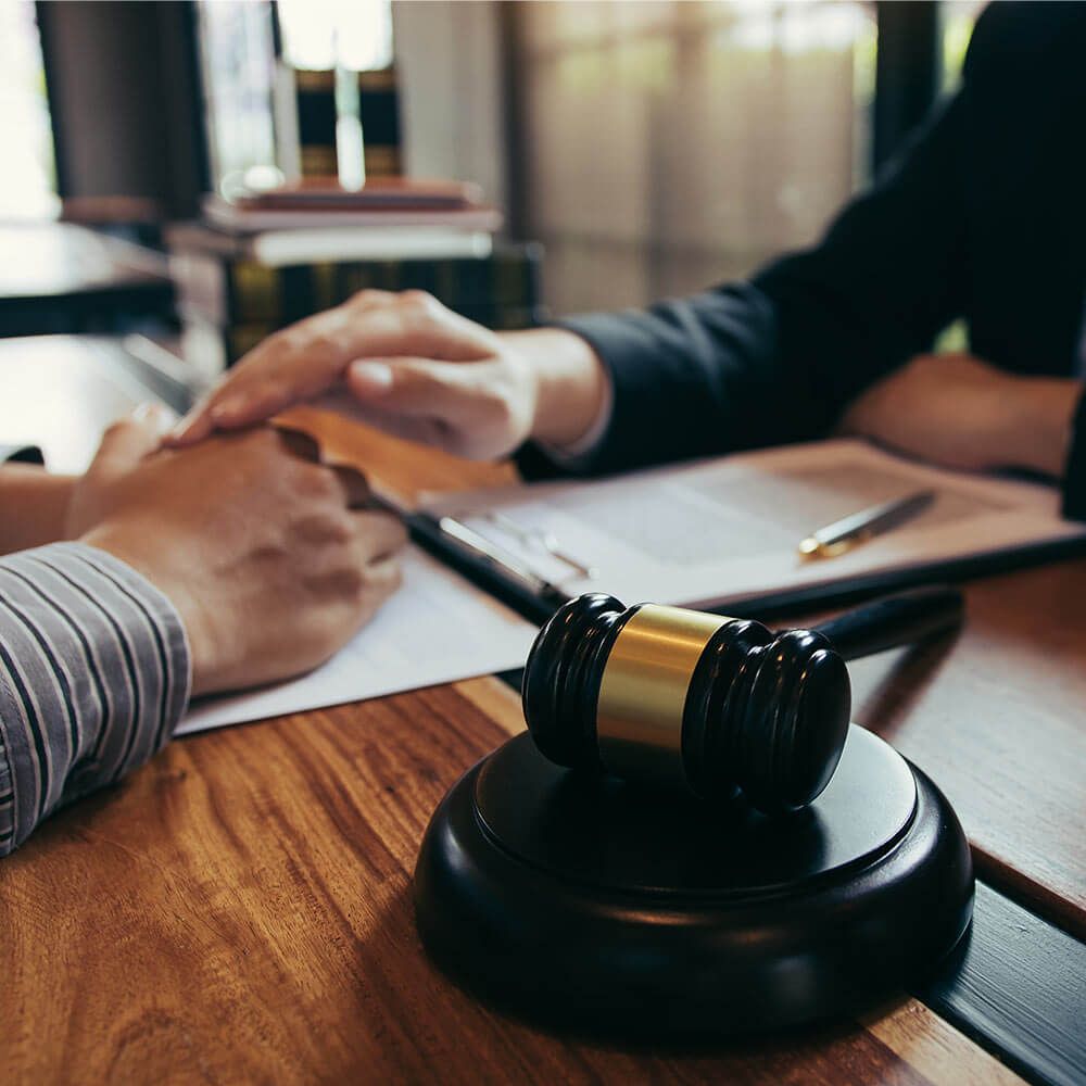 Lawyer and the court are using their hands to console the client who is aware that they will not win the case.