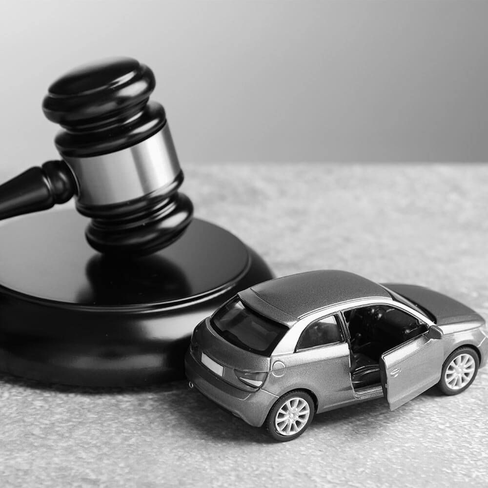 Motor vehicle accident law. Gavel and car model on grey background