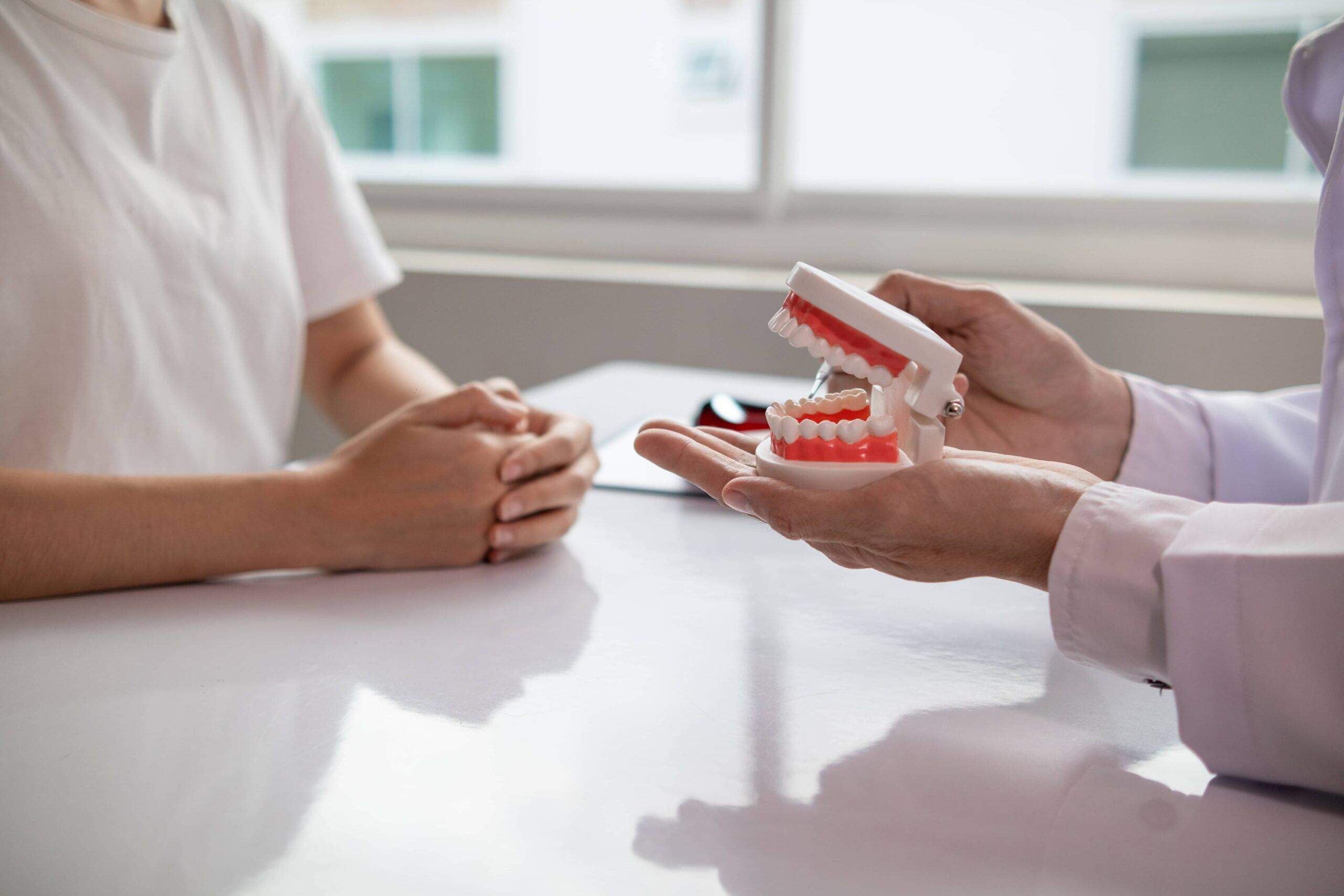 woman consults dentist about her toothache for treatment in dental clinic