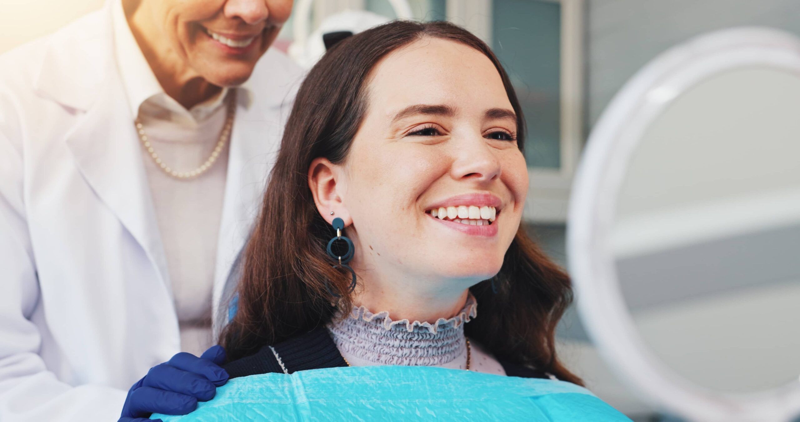 Teeth, smile and mirror with woman at dentist for dental care, treatment and fresh breath.