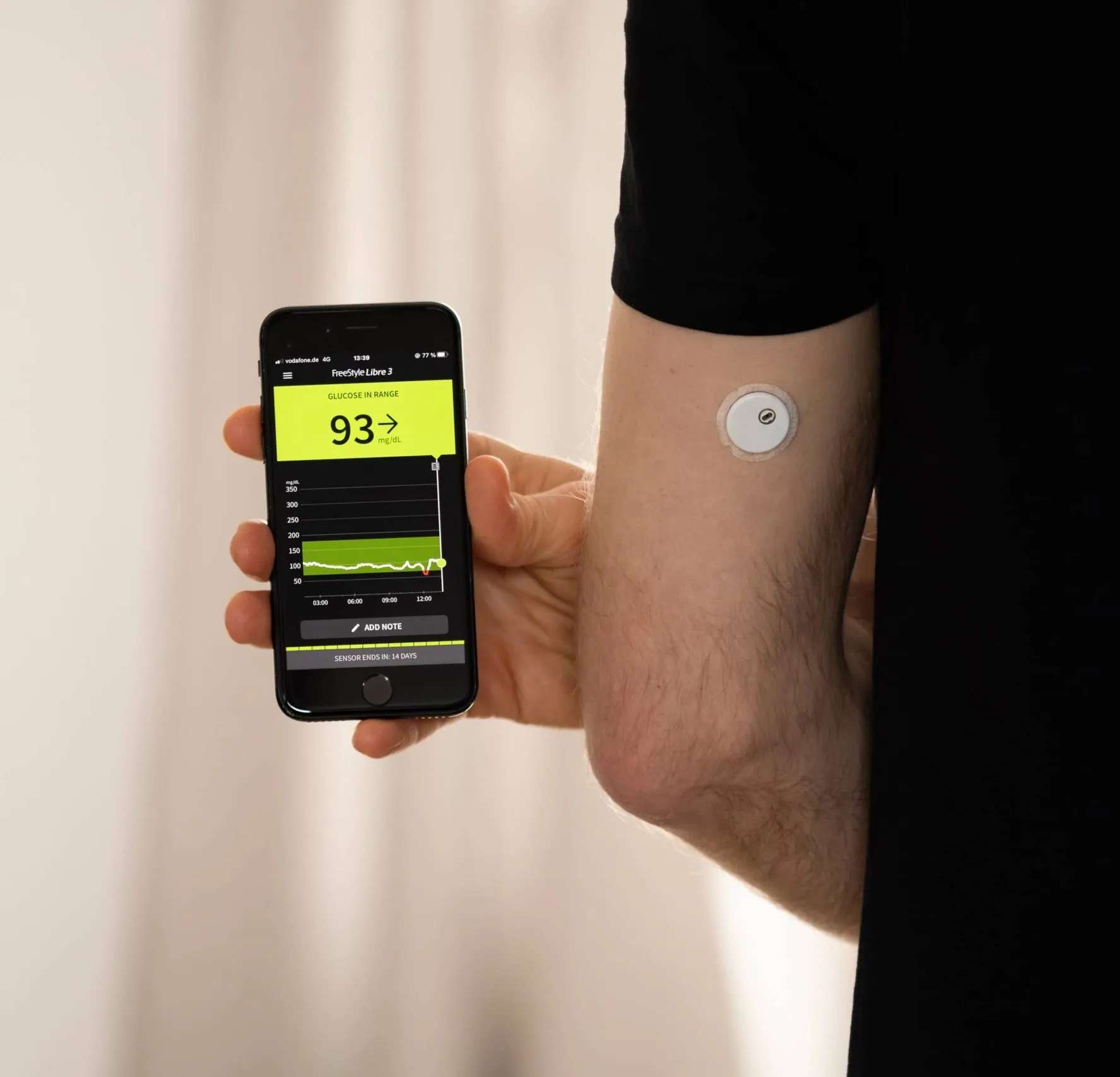 FreeStyle Libre 3 sensor and app on the smartphone. CGM device is measuring the glucose in the tissue