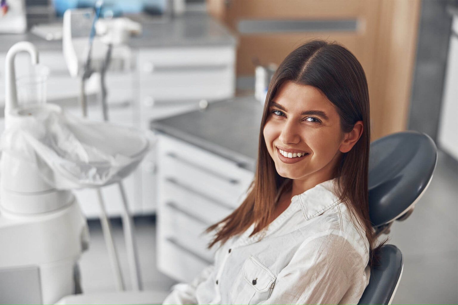 Happy woman at dentist cabinet