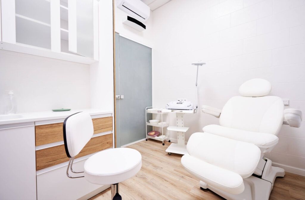 Light interior of modern aesthetic cosmetolody clinic with chair for patient and equipment for cosmetic procedures