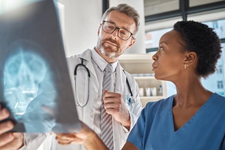 Brain, x ray and neurology doctors in a meeting working on a skull injury in emergency room in a hospital
