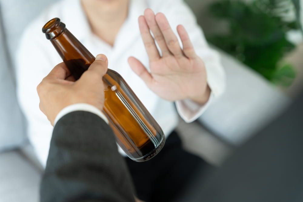 man refuses say no and avoid to drink an alcohol whiskey