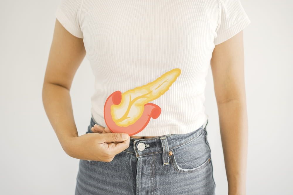 Woman hands holding pancreas, pancreatitis and pancreatic cancer concept