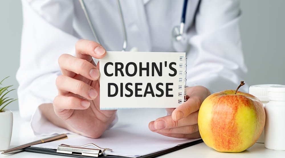 Doctor holding a tablet pc with Crohn's disease sign on the notebook