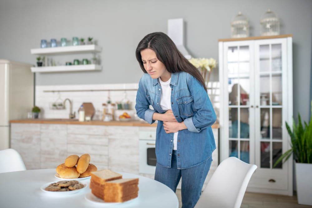A woman having a stomach ache because of gluten intolerance