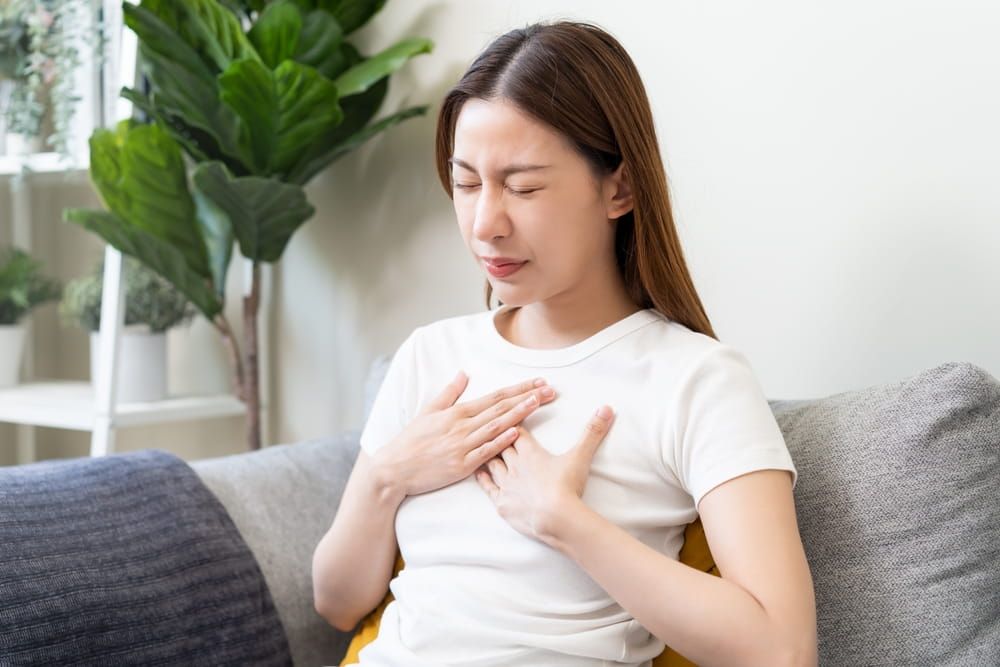 Acid reflux disease, suffer asian young woman have symptom gastroesophageal