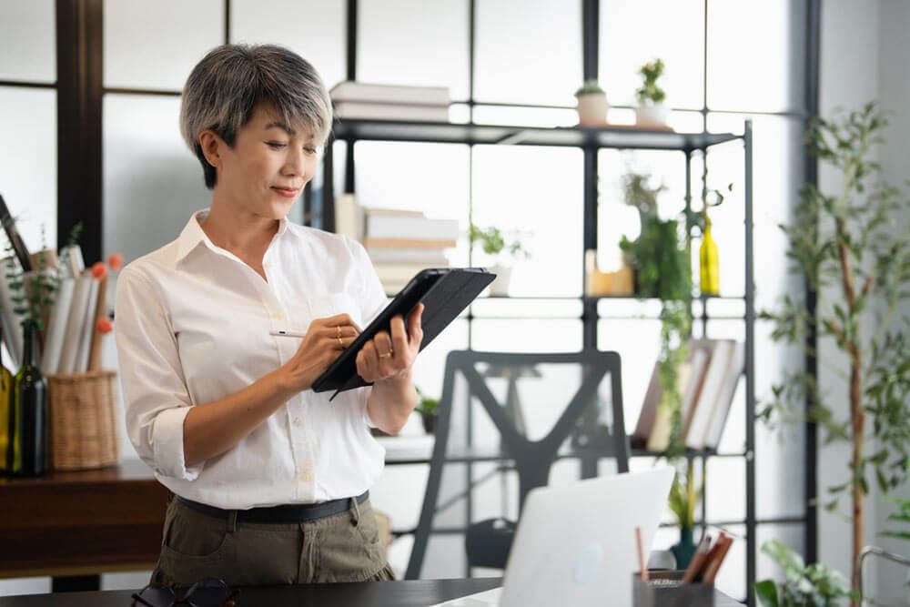 Smiling confident woman standing in an office