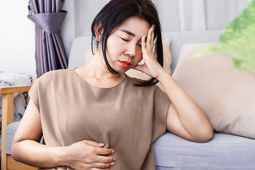 stress Asian woman have problems with digestion systems, stomachache, irritable bowel syndrome ( IBS)