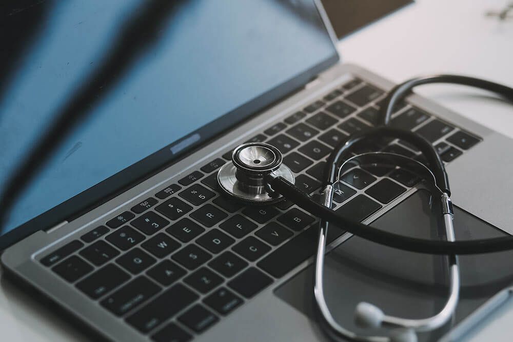Stethoscope with prescription clipboard and Laptop
