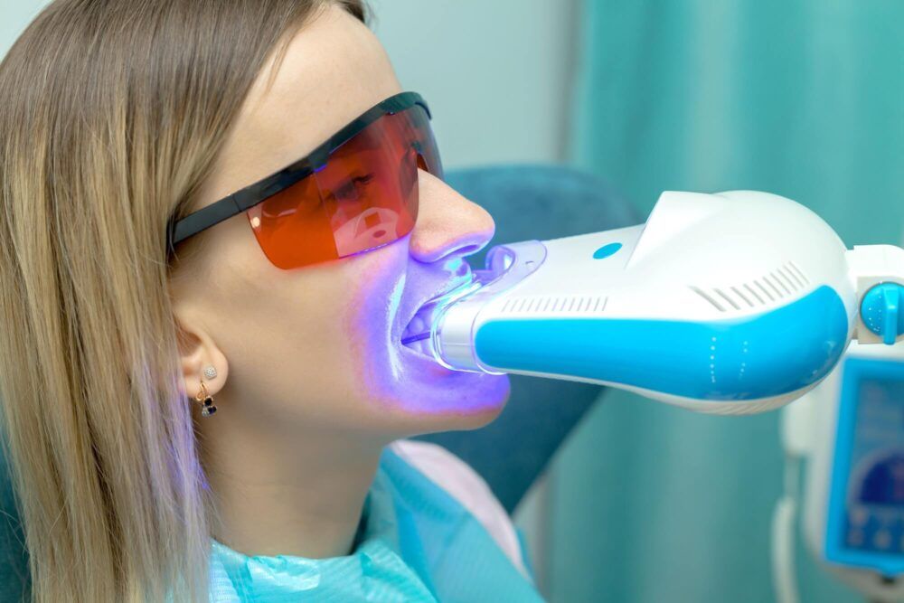 UV whitening teeth procedure. Dental care concept