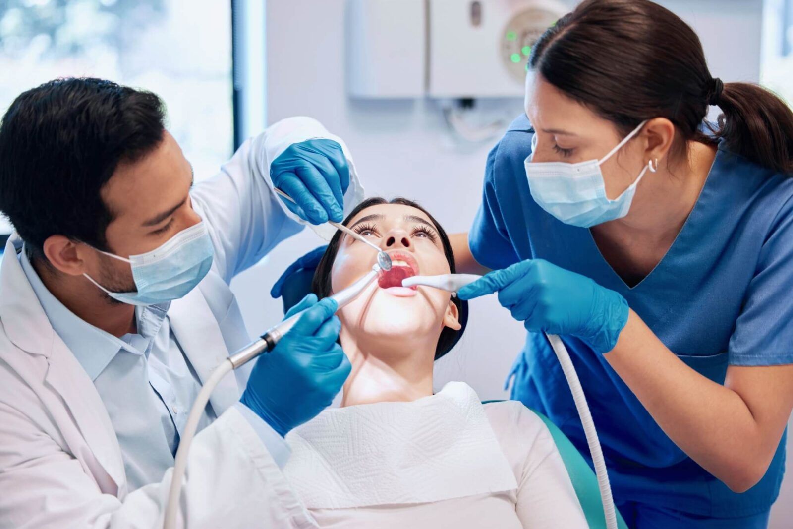 Dentist team, patient and cleaning mouth for hygiene with healthcare and consultation, surgery and tooth extraction
