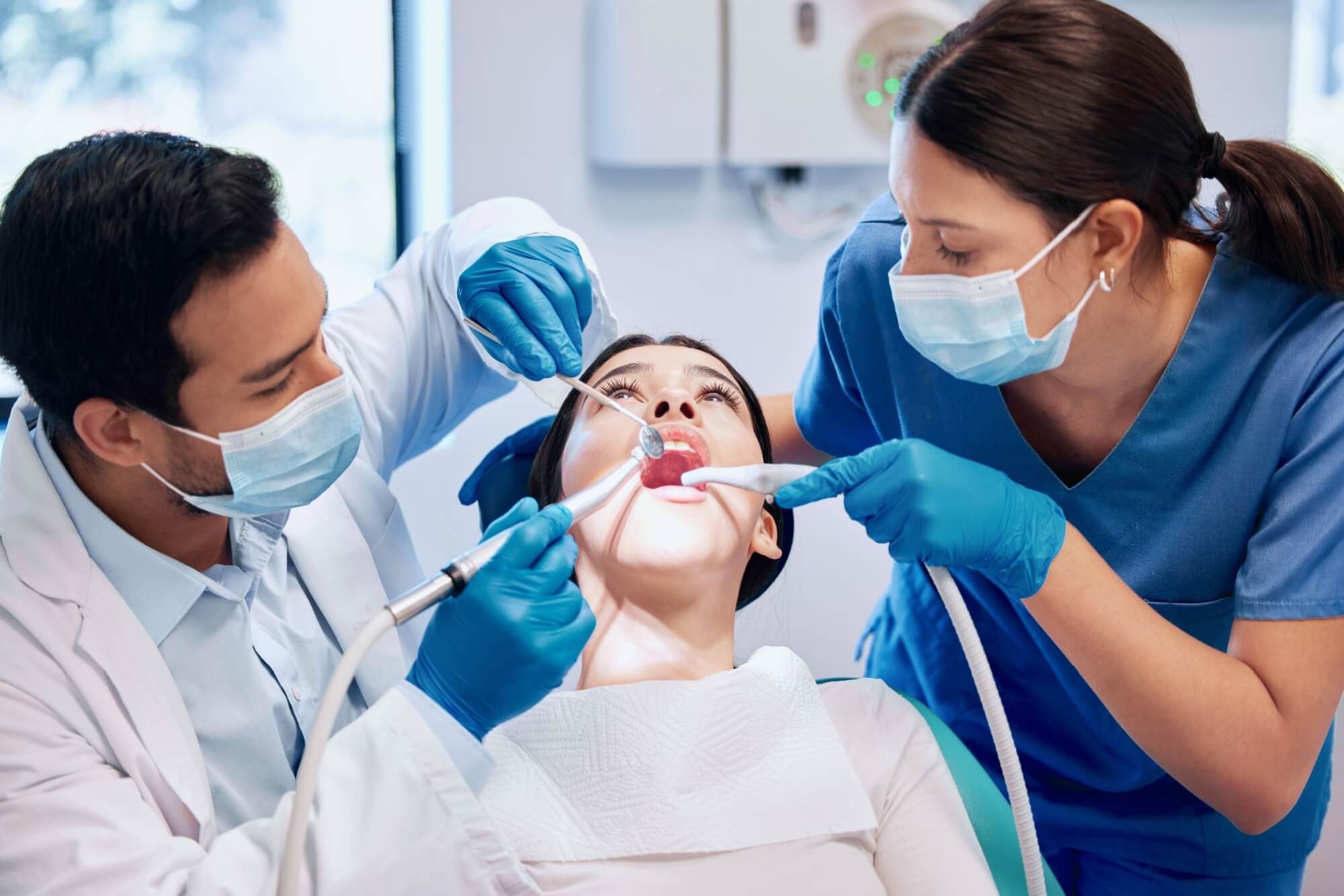 Dentist team, patient and cleaning mouth for hygiene with healthcare and consultation, surgery and tooth extraction