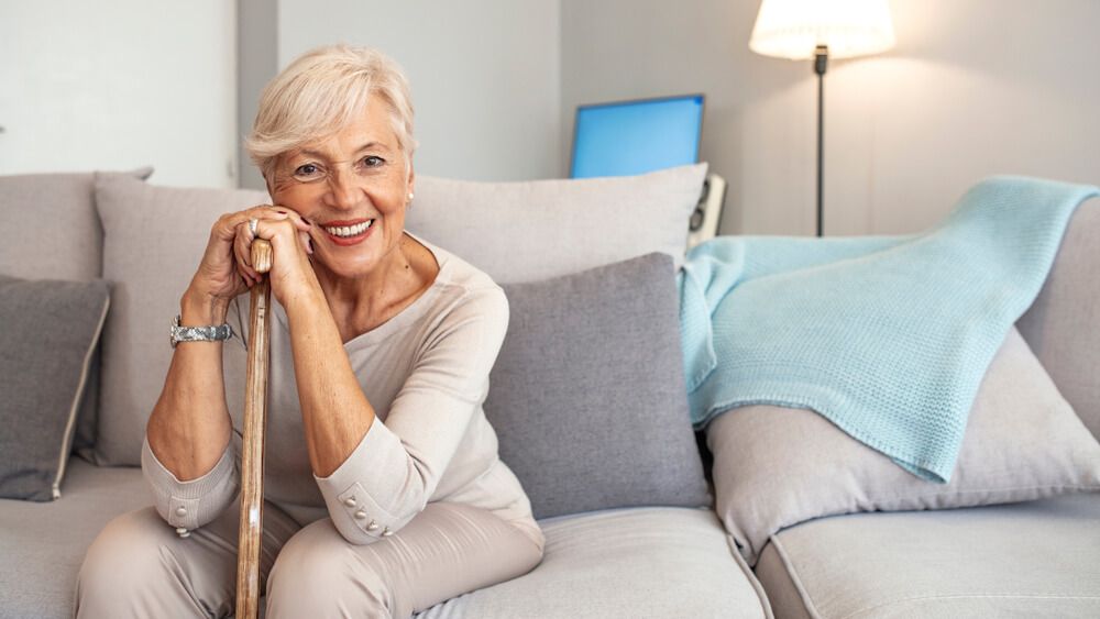 Smiling grandmother sitting on couch