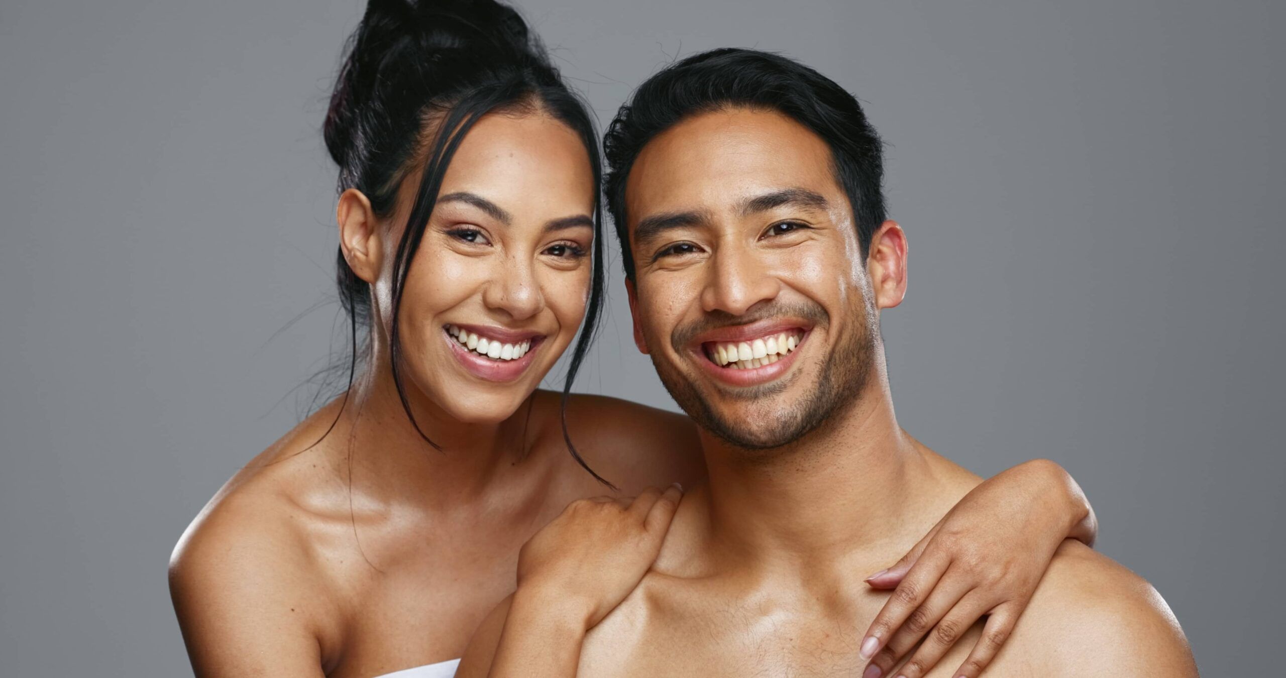 Smiling man and woman with healthy, radiant skin representing aesthetic treatments, medical-grade skincare, facial rejuvenation, and confidence-focused wellness care.