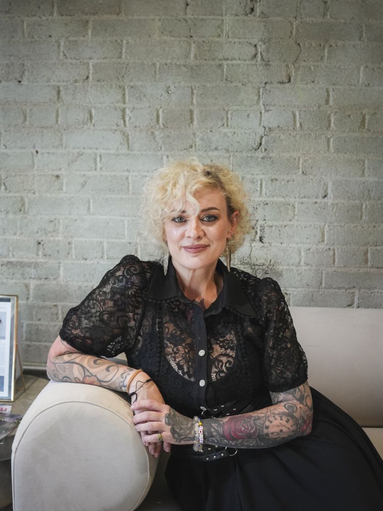 Amy Head, LME, seated in a professional headshot at Arvé Aesthetics.