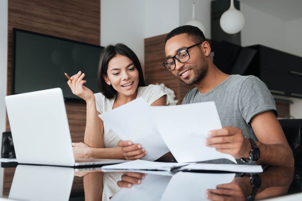 a couple reviewing financial documents together at home