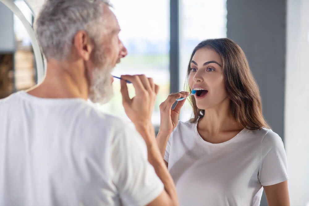 a couple engaging in a daily oral hygiene routine