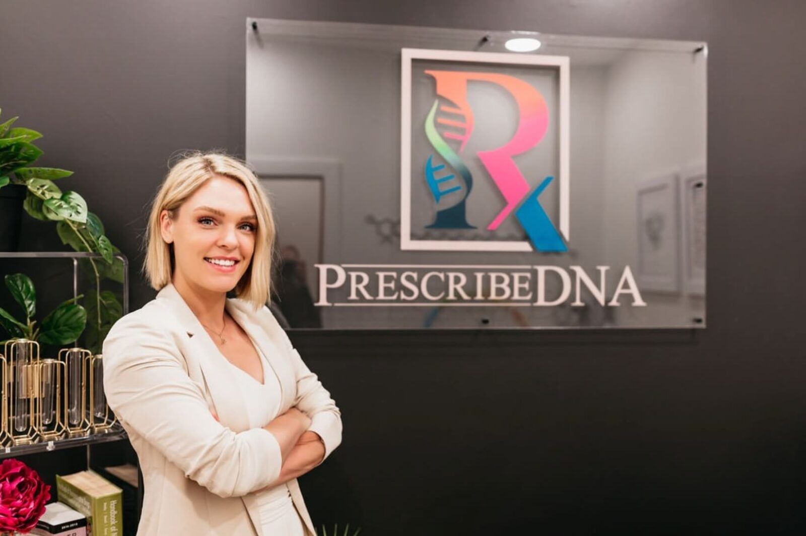 a person standing next to a sign for PrescribeDNA