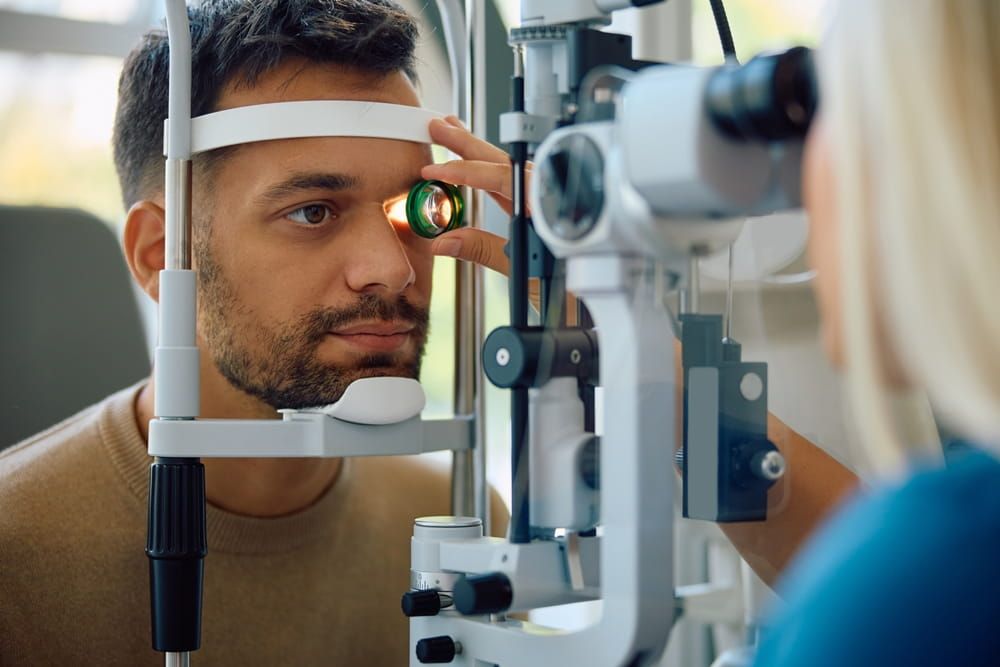 Young man having his eyes checked during a visit at oculist's office.